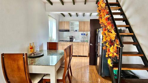 eine Küche und ein Esszimmer mit einem Tisch und einer Treppe in der Unterkunft Madre Tierra- Casa hospedaje in Villa de Leyva