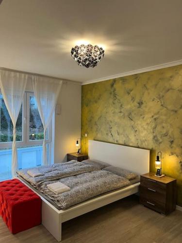 a bedroom with a large bed and a chandelier at Deluxe Apartment Bochum 1 BEDROOM in Bochum