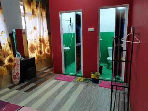 a bathroom with two glass doors and a toilet at VILLA HAJAH RUGAYAH BAKRI MUAR in Muar