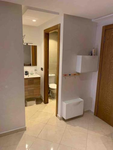 a bathroom with a toilet and a sink at Appart familial chic & confort in Kenitra