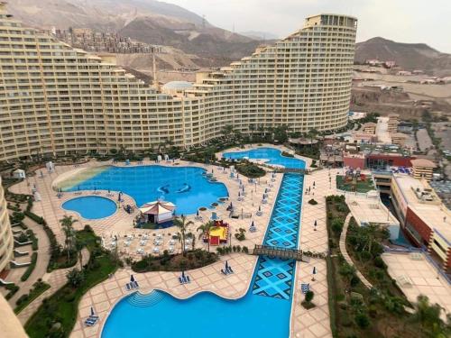 an aerial view of a resort with several pools at Pyramids Porto El Sokhna Familis Only in Ain Sokhna