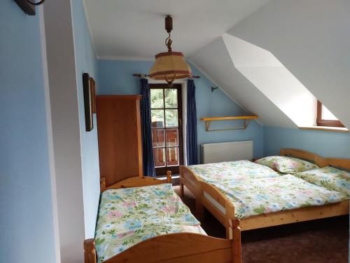 a bedroom with two beds and a window at Bavorská chata in Železná Ruda