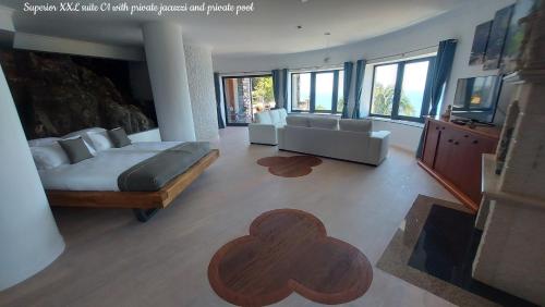 a bedroom with a bed and a living room at Castelo do Mar, Madeira in Tábua