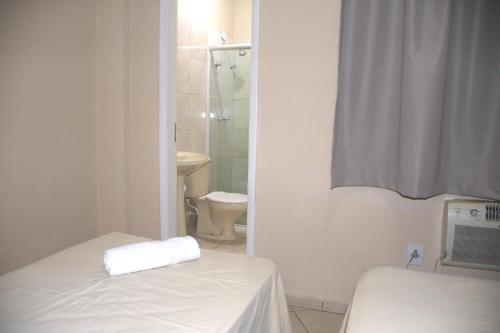 łazienka z łóżkiem, toaletą i prysznicem w obiekcie Pé da Serra Hotel w mieście Resende