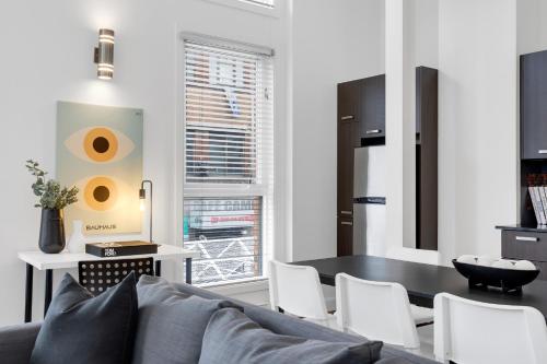 a living room with a couch and a table at LiV MTL Main in Montréal