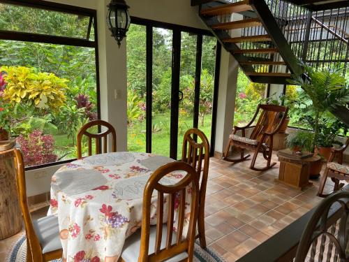 a dining room with a table and chairs on a porch at Serenity in Fortuna
