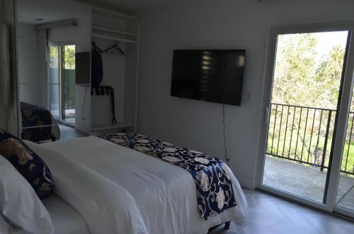 a bedroom with a bed and a sliding glass door at Dimond Abode Vacation Home 2 in Oakland