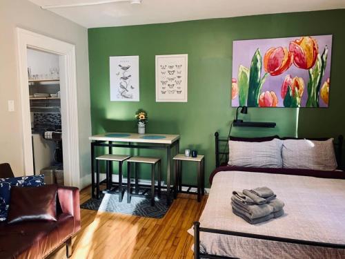 a bedroom with a bed and a table in a room at Comfy Studio #3, Central Location, Parking in Halifax