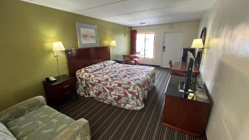 a hotel room with a bed and a couch at Gulf Way Inn Clearwater in Clearwater