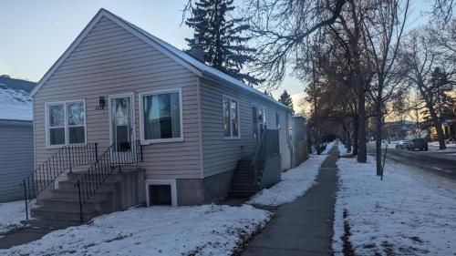 a house with snow on the side of it at Private Family Hideaway or Business Travel in Edmonton - 2 Bedroom Apartment in Edmonton