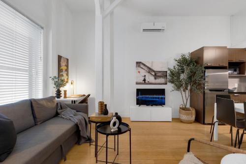 a living room with a couch and a kitchen at LiV MTL Main in Montréal