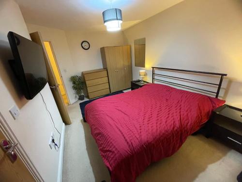 伯明罕的住宿－Luxury ensuite room near city centre，一间卧室配有一张带红色毯子的大床