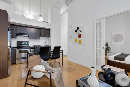 a living room with a kitchen and a dining room at LiV MTL Main in Montréal