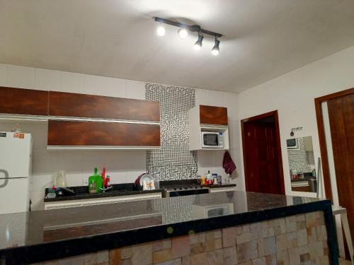 a kitchen with a sink and a counter top at Casa Temporada peterle Iriri in Iriri