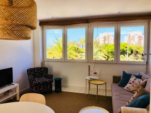 a living room with a couch and two windows at One bedroom appartement with wifi at Cartagena in Cabo de Palos