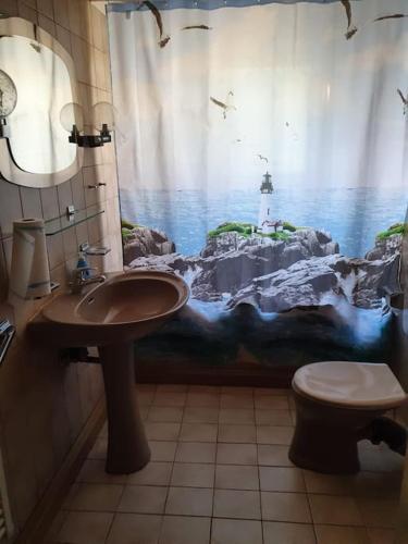 a bathroom with a sink and a shower curtain with a lighthouse at 3 Z. Appartment, Zentral, Nähe Messe Köln Deutz in Cologne