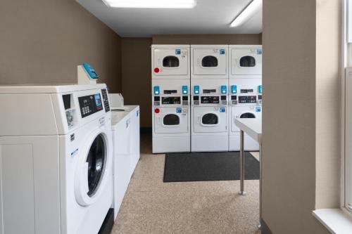 a laundry room with white washers and dryers at Residence Inn Long Island Holtsville in Holtsville