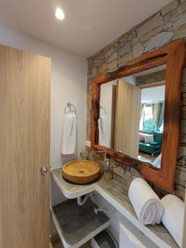 a bathroom with a wooden sink and a mirror at loft grupo y parejas AZUCENAS in Jardin