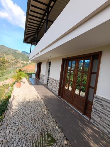 a house with a pathway leading to the front door at loft grupo y parejas AZUCENAS in Jardin