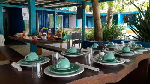 a table with green dishes on top of it at Beija Flor in Gamboa