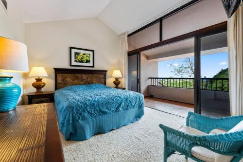 a bedroom with a blue bed and a balcony at Kaanapali Royal Q302-Oceanview spacious 2 bedroom Kaanapali Royal gem in Lahaina