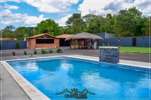 a swimming pool in a yard with a gazebo at CHcasaquinta in Paraguarí
