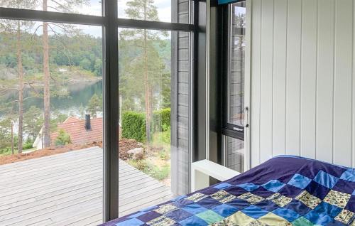 a bedroom with a window looking out at a lake at Gorgeous Home In Gumy With Kitchen 