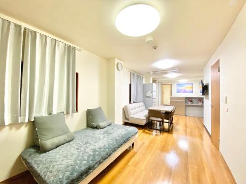 a living room with a couch and a chair at Asakusa正和House in Tokyo