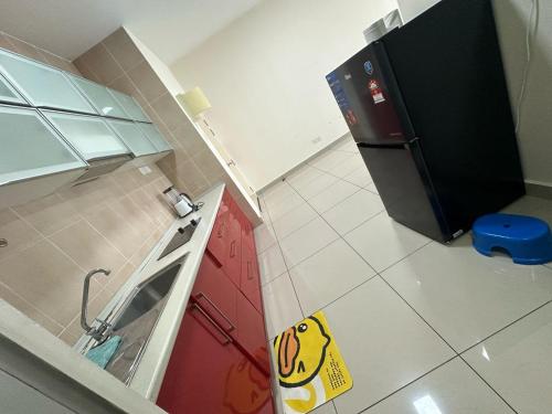 a kitchen with a yellow smiley face sign on the floor at Pavilion Bukit Jalil, Old Klang Road, Puchong, Bukit OUG, 9 pax B1 in Kuala Lumpur