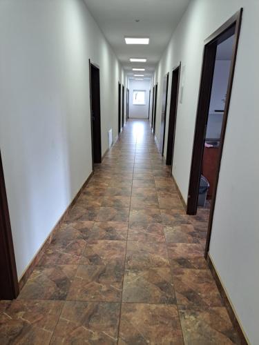 a hallway of an office building with a tile floor at Zajazd Izabell 