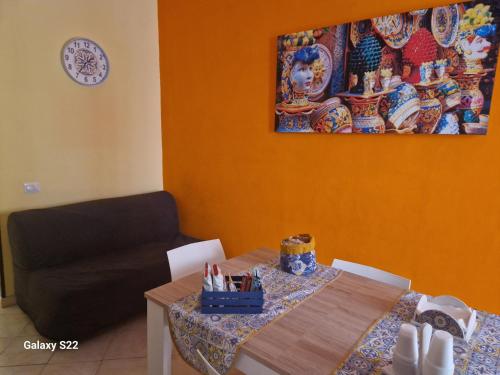 a living room with a table and a couch at Sikelia House Cefalù in Cefalù