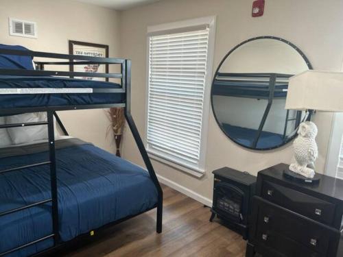 a bedroom with a bunk bed and a mirror at King Resort in Branson