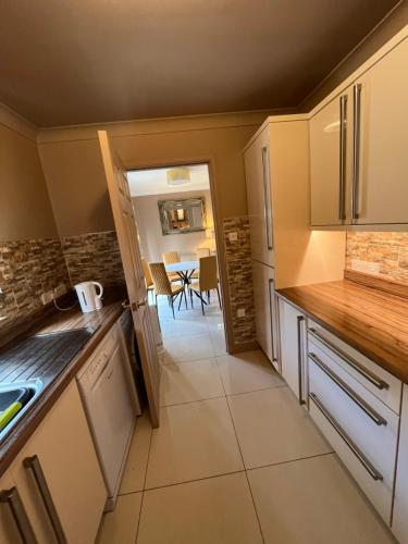 a kitchen with a counter and a table in a room at Retreat at The Knowe Auchincruive Estate in Ayr