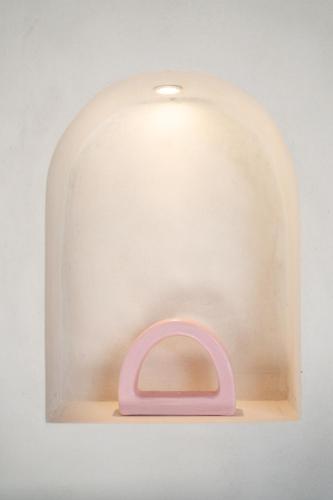 a glass dome with a pink item on a shelf at J4 Villas Sanur in Sanur