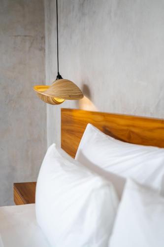 a bedroom with a bed with a wooden head board at J4 Villas Sanur in Sanur