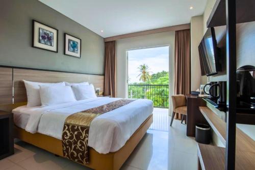 a hotel room with a bed and a balcony at Bluebells 1 BR Superior Room ZN33 in Senggigi 
