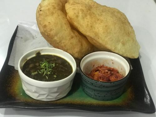 a plate of food with soup and a bread at Khadka niwas in Kohalpur