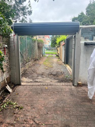 an entrance to an alley with an open door at Cloudy city in Sydney