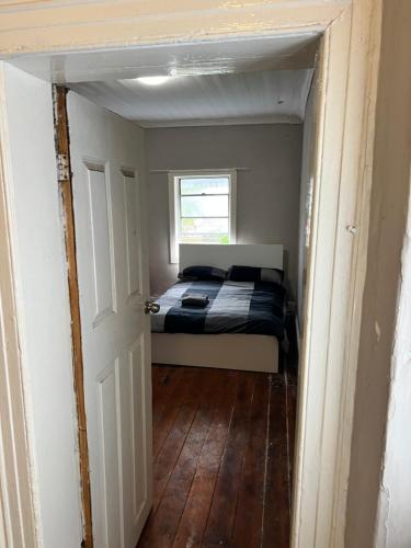 a small bedroom with a bed and a window at Cloudy city in Sydney