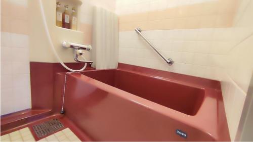 a red sink in a bathroom with a shower at Utazu Grand Hotel in Utazu
