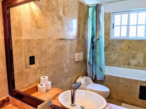 a bathroom with a sink and a shower and a toilet at Castillo Playacar Fase 1 9br 3Kitchen Pool walk to Beach 5th Ave 25max in Playa del Carmen