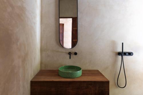 a bathroom with a green sink on a wooden table at Be Zanzibar Boutique Hotel in Mfumbwi