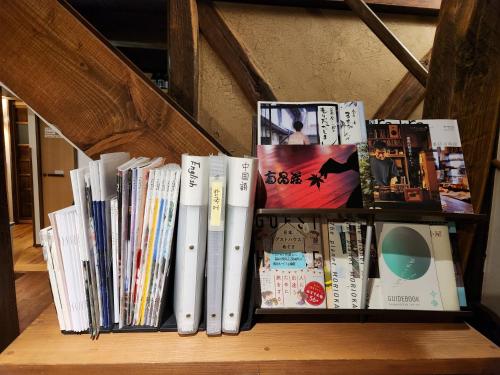 a book shelf with a bunch of books at Tototo Morioka in Morioka