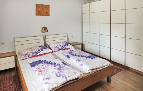 two beds in a room with white tiled walls at Awesome Apartment In Kappl With 3 Bedrooms And Internet in Kappl