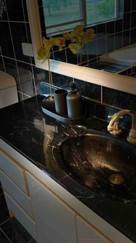 a kitchen counter with a sink in a kitchen at Dhanda Farm Bathurst in Raglan