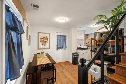 a kitchen with a staircase and a table in a room at Unique home surrounded by nature 7 mins from DC in Arlington