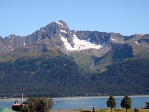 a snow covered mountain with a lake in front of it at Murphy's Alaskan Inn in Seward