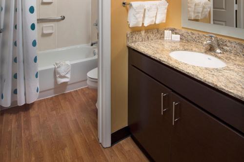 a bathroom with a sink and a toilet and a shower at TownePlace Suites by Marriott Atlanta Alpharetta in Alpharetta