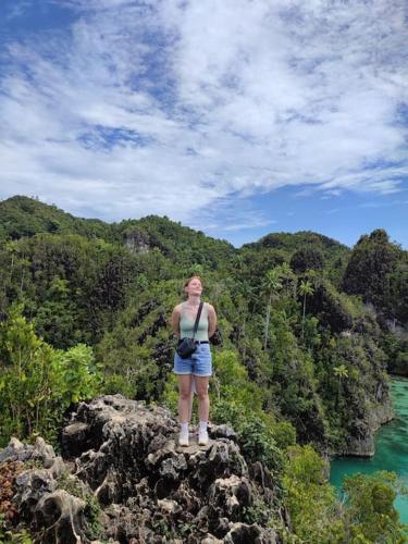 a woman standing on top of a rock near the water at Flotopia villa in Yennanas Besir