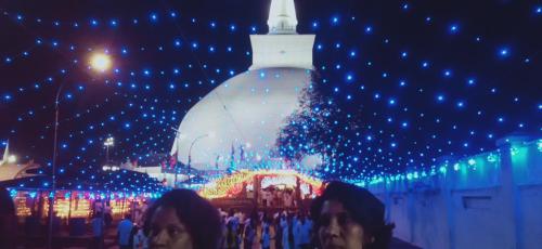 a group of people standing in front of a christmas tree at Sidhangana Home Stay in Anuradhapura